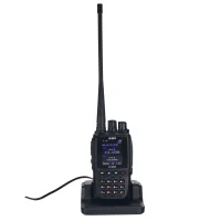 alinco-dj-md5 handheld ham radio sitting in a charging dock