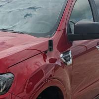 compact gmrs antenna mounted to the fender of a ford ranger