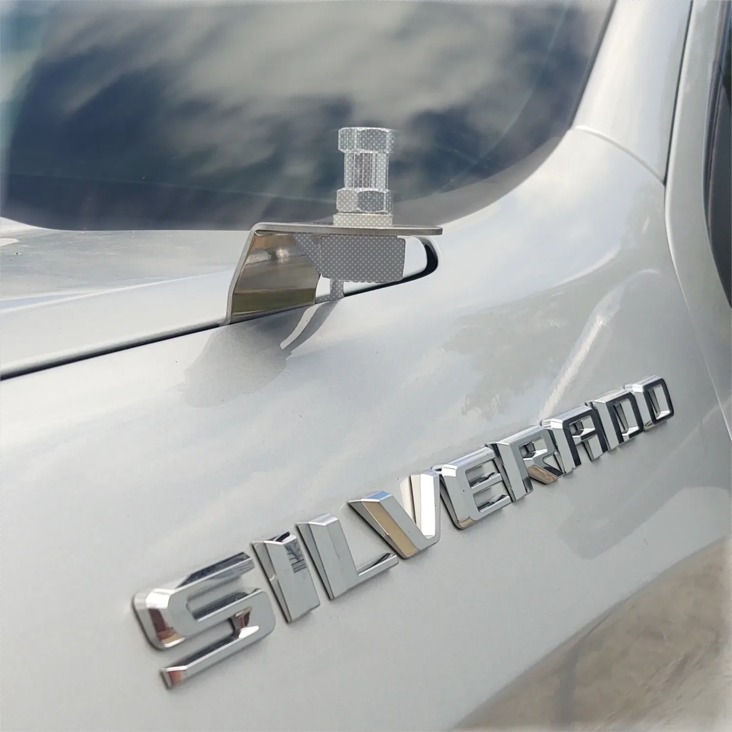 stainless steel antenna mount installed to the fender of a  Chevy Silverado