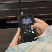 A radio enthusiast pressing the menu button on a TRX-1 from Whistler