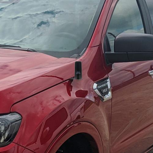 compact gmrs antenna mounted to the fender of a ford ranger