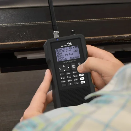 A radio enthusiast pressing the menu button on a TRX-1 from Whistler